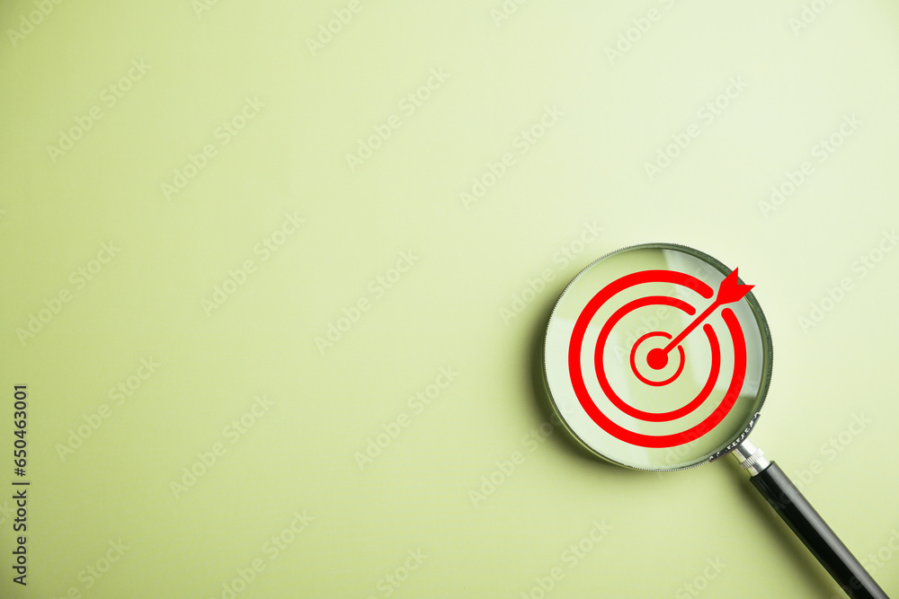 The magnifier glass centers on a target board, signifying focused business objectives., it represents the concept of search, goal attainment, strategic planning, and marketing success. The magnifier glass centers on a target board, signifying focused business objectives., it represents the concept of search, goal attainment, strategic planning, and marketing success.