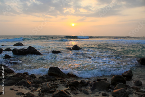 The sun setting into the sea at Delawella veach, Sri Lanka