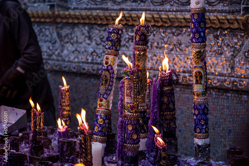 group of handmade and ornamental candles lit by the Lord of Miracles in Lima, Peru