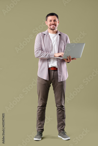 Man with laptop on color  background