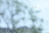 blur background with sunlight on rainy day, water droplet on mirror