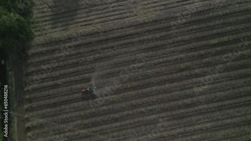 A tractor plowing the field in Maharashtra, India photo