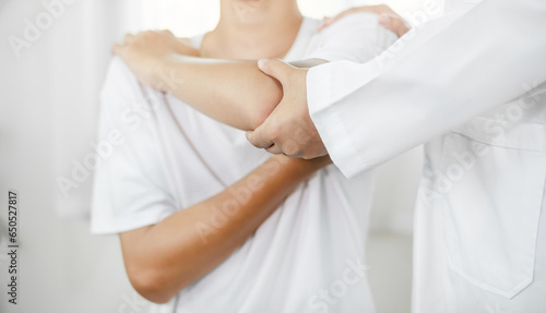 Female physiotherapists provide assistance to male patients with elbow injuries and examine patients in rehabilitation centers. Physiotherapy concepts