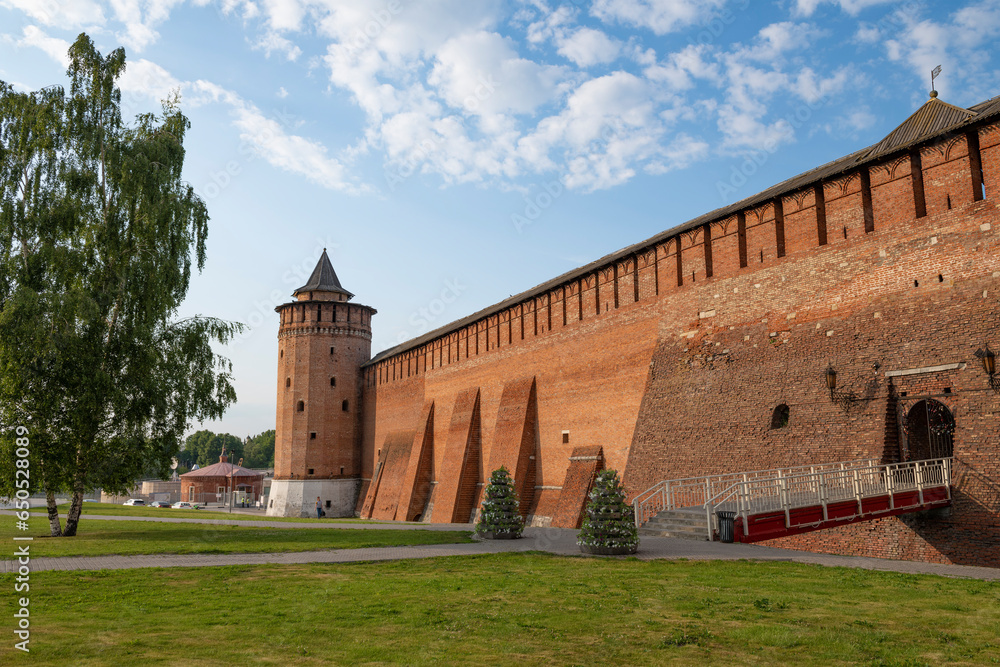 At the ancient wall of the Kolomna Kremlin on a sunny June evening. Staraya Kolomna. Moscow region, Russia At the ancient wall of the Kolomna Kremlin on a sunny June evening. Staraya Kolomna. Moscow region, Russia