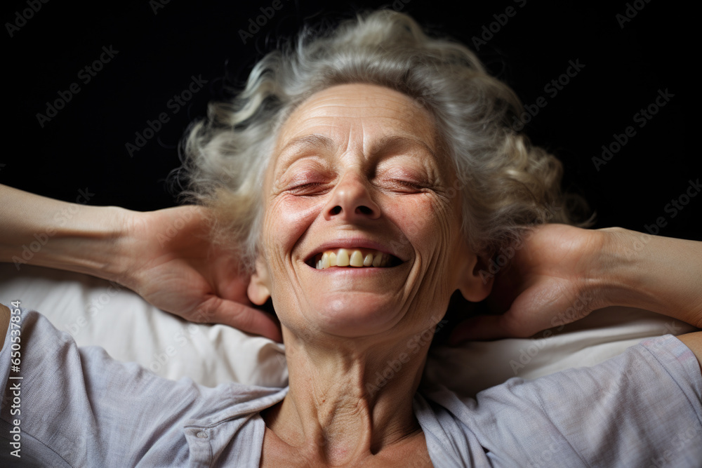 Older woman with warm smile laying comfortably on pillow. Perfect for depicting relaxation, comfort, and well-being. Older woman with warm smile laying comfortably on pillow. Perfect for depicting relaxation, comfort, and well-being.