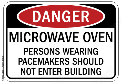 Magnetic field and pacemaker warning sign and labels microwave oven. Persons wearing pacemakers should not enter building