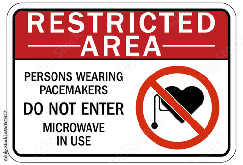 Magnetic field and pacemaker warning sign and labels Persons wearing pacemakers Do Not Enter. Microwave oven in use.