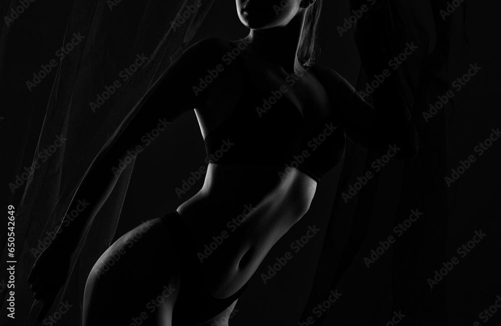 Slim sexy woman in lingerie on a dark background. Her body is illuminated with blue and red lights. - obrazy, fototapety, plakaty 