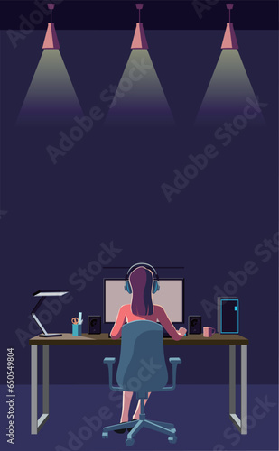 A woman back view operating a desktop computer in a dark room. Remote work. Overtime