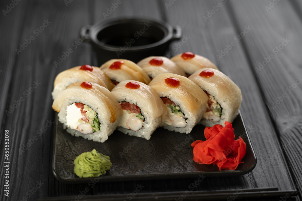 Sushi set with caviar, avocado and salmon. Asian cuisine. Top view. Free space for your text. Sushi set with caviar, avocado and salmon. Asian cuisine. Top view. Free space for your text.