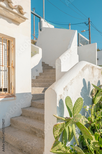 Stairs, exterior architecture background, sunlight and shadow on surface of stairway to street of white building against blue clear sky