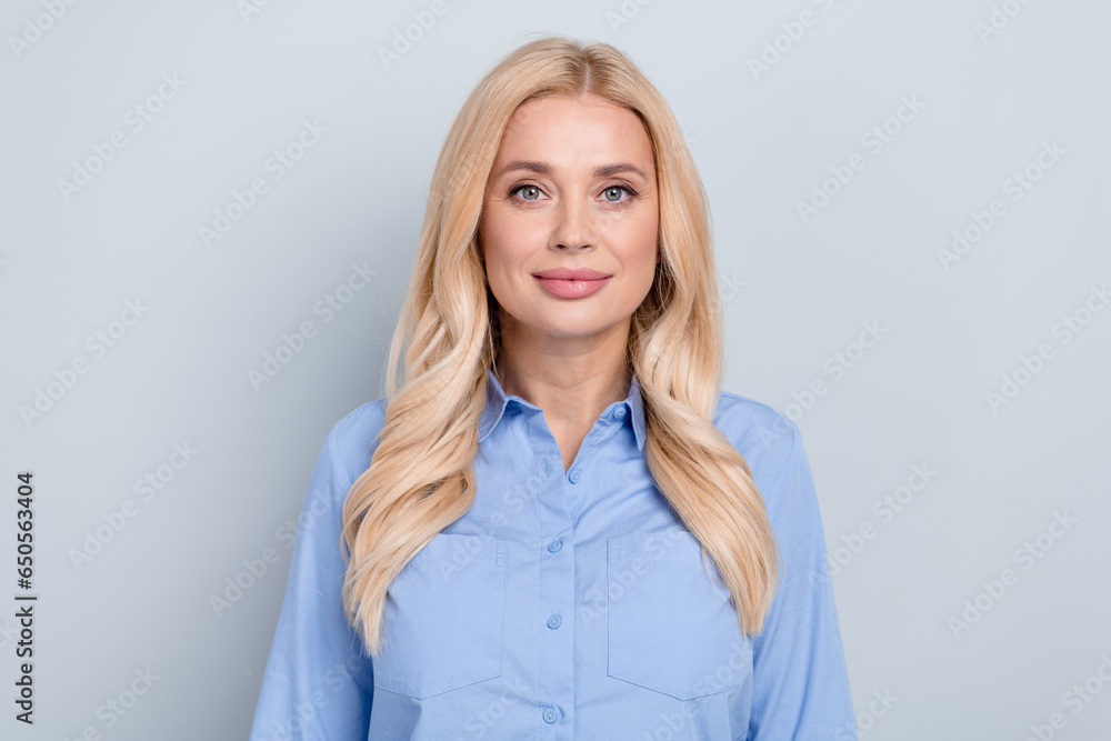 Photo of representative director mature lady wear blue shirt blonde curly blonde hair finance manager isolated on grey color background Photo of representative director mature lady wear blue shirt blonde curly blonde hair finance manager isolated on grey color background