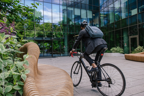 Young manager commuting to the office on a bike photo