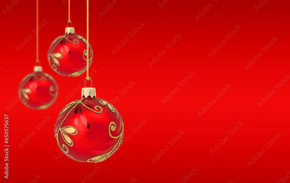 Hanging Christmas ornaments on red background with copy space Hanging Christmas ornaments on red background with copy space