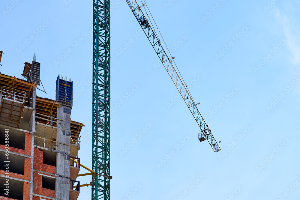 Large construction high rise crane and clear blue sky