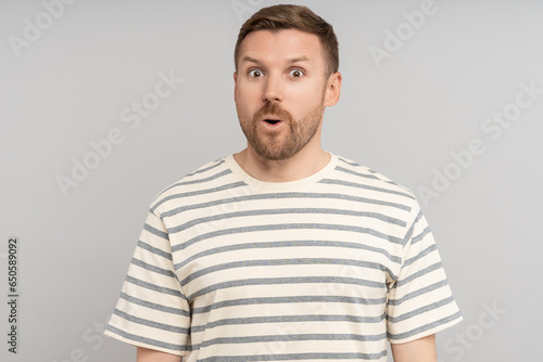 Astonished man looking open mouth in amazement, omg, surprised from ad offer opportunity. Shocked middle aged caucasian male with excited expression round eyes, isolated studio background. Omg, wow