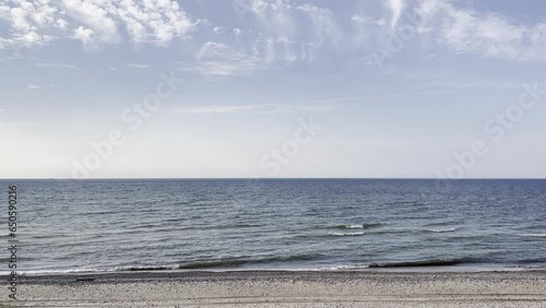 A peaceful day in Latvia, Ventspls, at Baltic Sea beach. Windy, sunny, relaxing with a view of the sea and waves. 