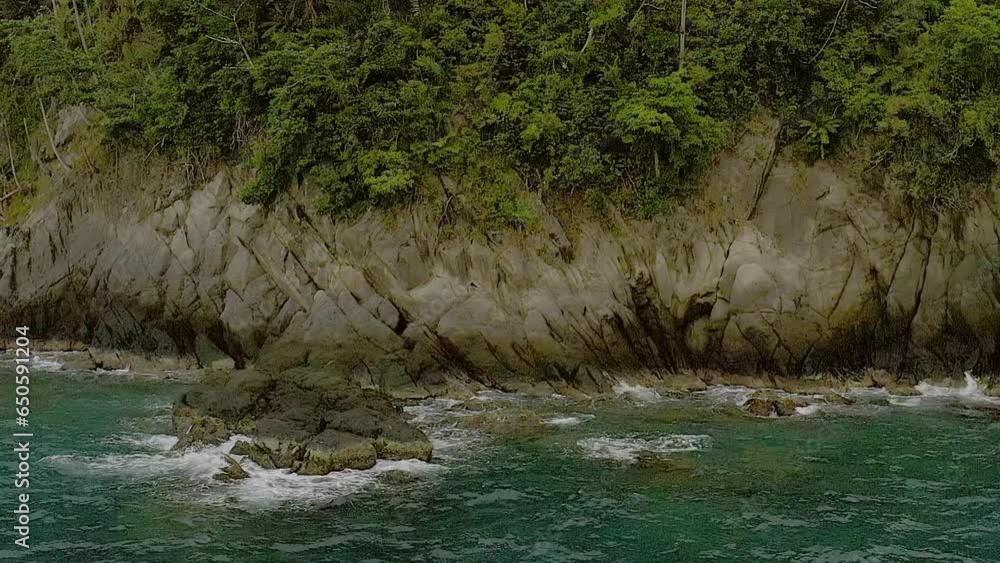 Ocean waves crash peacefully across banded tropical rocks of Looc beach sirigao Ocean waves crash peacefully across banded tropical rocks of Looc beach sirigao