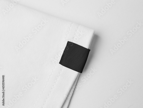 Blank black colour clothing label on white t shirt sleeve