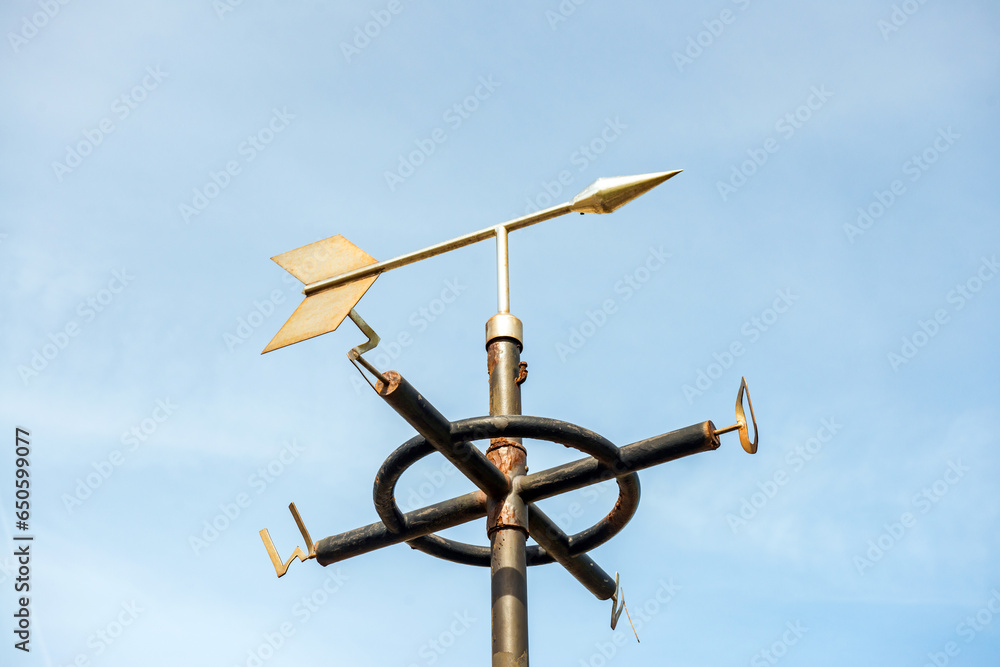 White Weathervane Against a Radiant Blue Sky White Weathervane Against a Radiant Blue Sky