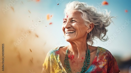 elderly woman having fun at Holi festival