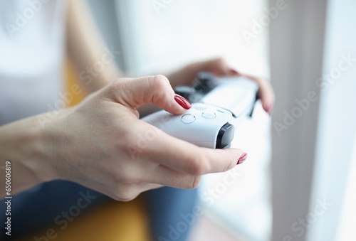Woman playing computer game with joystick closeup. Entertainment and leisure concept