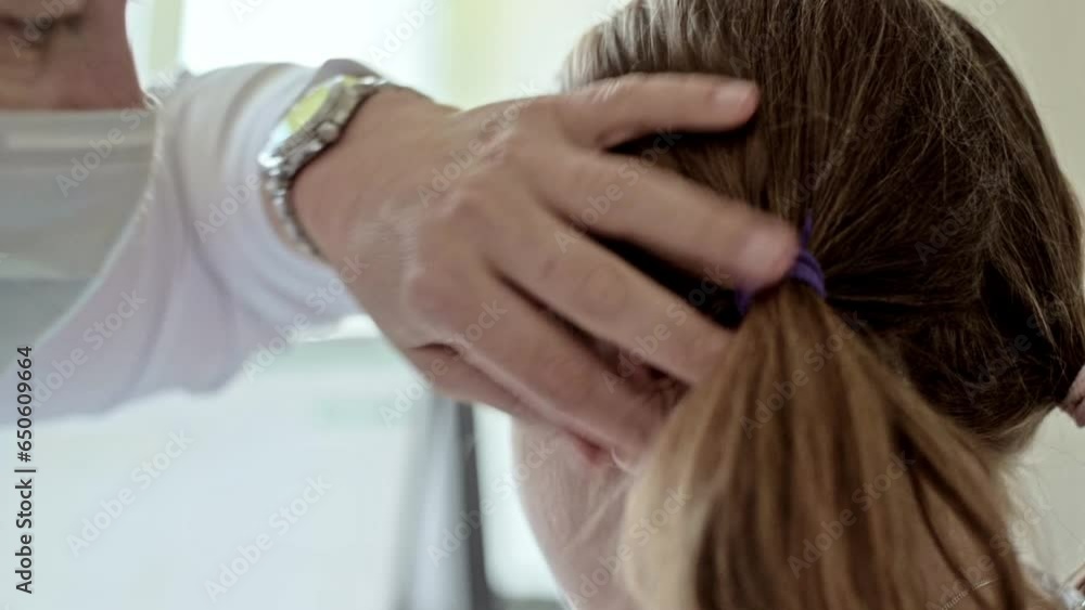 Russia little girl child being examined by an ENT doctor in the clinic. High quality FullHD footage Russia little girl child being examined by an ENT doctor in the clinic. High quality FullHD footage