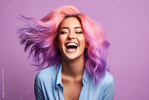 Happy young woman with colored hair fall outfit and a smartphone in her hands laughs with jo