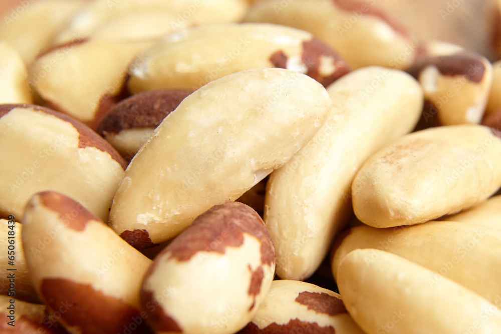 Fototapeta premium Brazil nuts closeup as background. Shelled nuts. Brown Brazil nut kernels, a healthy choice