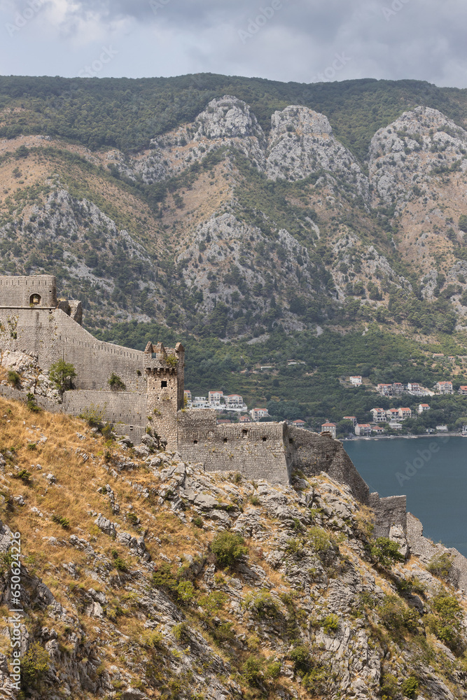 Walls of the Kotor Fortress with mountains in the background. Kotor, Montenegro