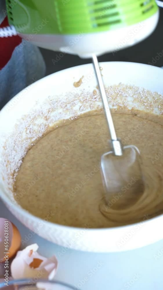 electric rod mixing the dough of a sponge cake in a bowl electric rod mixing the dough of a sponge cake in a bowl