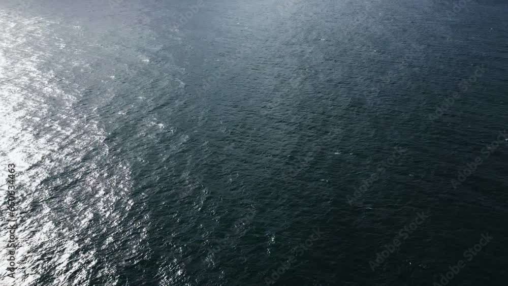 Aerial view unfolds of the boundless sea and powerful waves merging with the endless horizon. Aerial view unfolds of the boundless sea and powerful waves merging with the endless horizon.