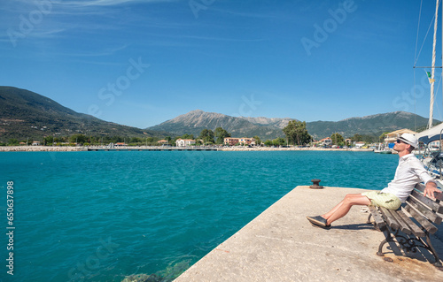 A tourist is enjoying his vacation in Greece by the Ionian sea