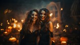 Two beautiful young women in black halloween costumes  at Halloween party.