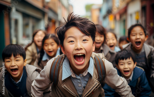 A group of happy and playful Asians children in the foreground who runs in the street and are laughing their heads off