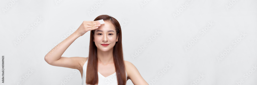 beautiful happy asian girl model with natural makeup using oil absorbing sheets. panorama. beautiful happy asian girl model with natural makeup using oil absorbing sheets. panorama.
