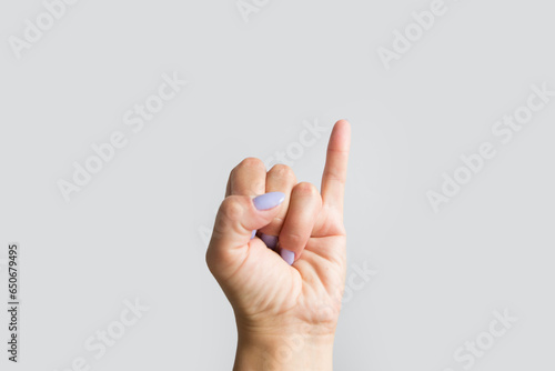 hand showing the gesture with raised up his pinky photo