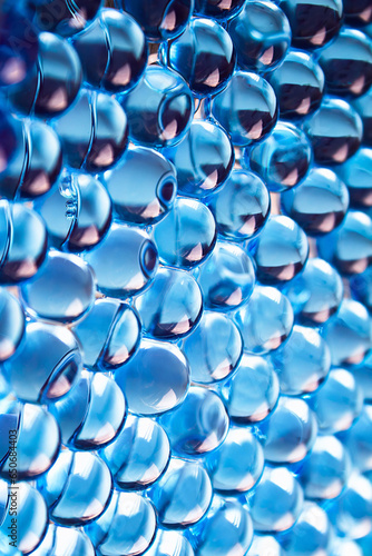 Macro of blue gel balls. Watery polymer hydrogel background. Crystal liquid. Transparent texture	