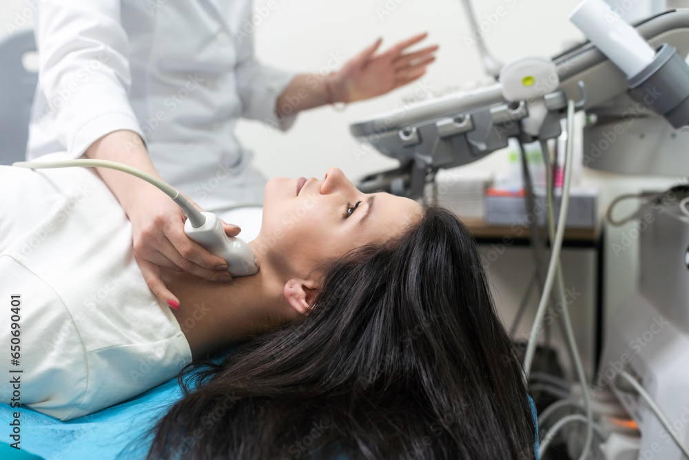 Qualified medical specialist using ultrasound equipment in the clinic Qualified medical specialist using ultrasound equipment in the clinic