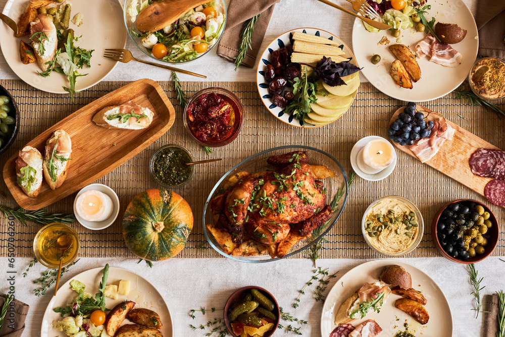 Top view background of cozy dinner table set for Thanksgiving with delicious roasted turkey and comfort food, copy space Top view background of cozy dinner table set for Thanksgiving with delicious roasted turkey and comfort food, copy space