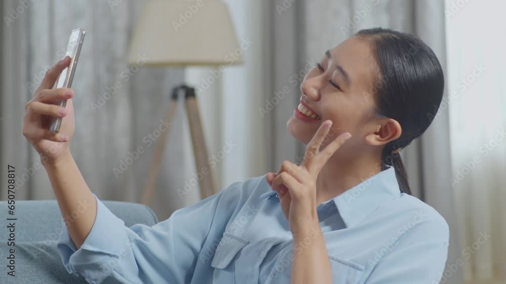Close Up Of Cheerful Asian Woman Using Smartphone Taking Selfie While Lying On Sofa In The Living Room
Close Up Of Cheerful Asian Woman Using Smartphone Taking Selfie While Lying On Sofa In The Living Room