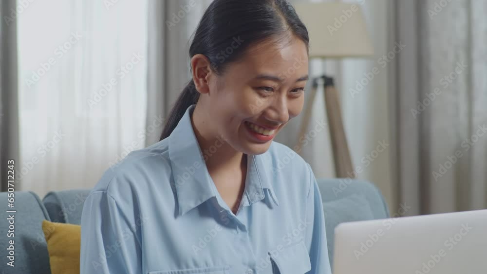 Close Up Of Asian Woman Celebrating Finish Typing On A Laptop Computer While Sitting On Sofa In The Living Room
Close Up Of Asian Woman Celebrating Finish Typing On A Laptop Computer While Sitting On Sofa In The Living Room