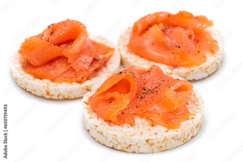 Tasty Rice Cake Sandwiches with Fresh Salmon Slices Isolated on White. Easy Breakfast and Diet Food. Crispbread with Red Fish. Healthy Dietary Snacks - Isolation