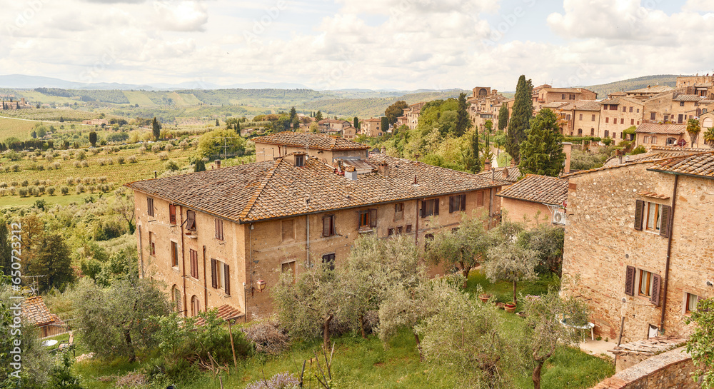 Typical house of the medieval city of San Gimignano surrounded by the Tuscan countryside 