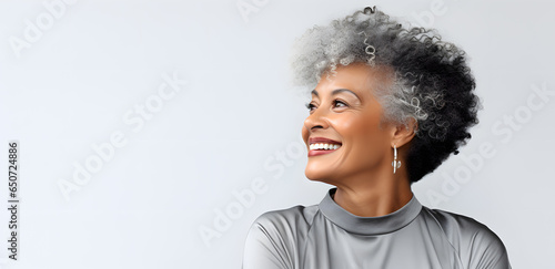 Beautiful african american senior woman portrait isolated on light grey background