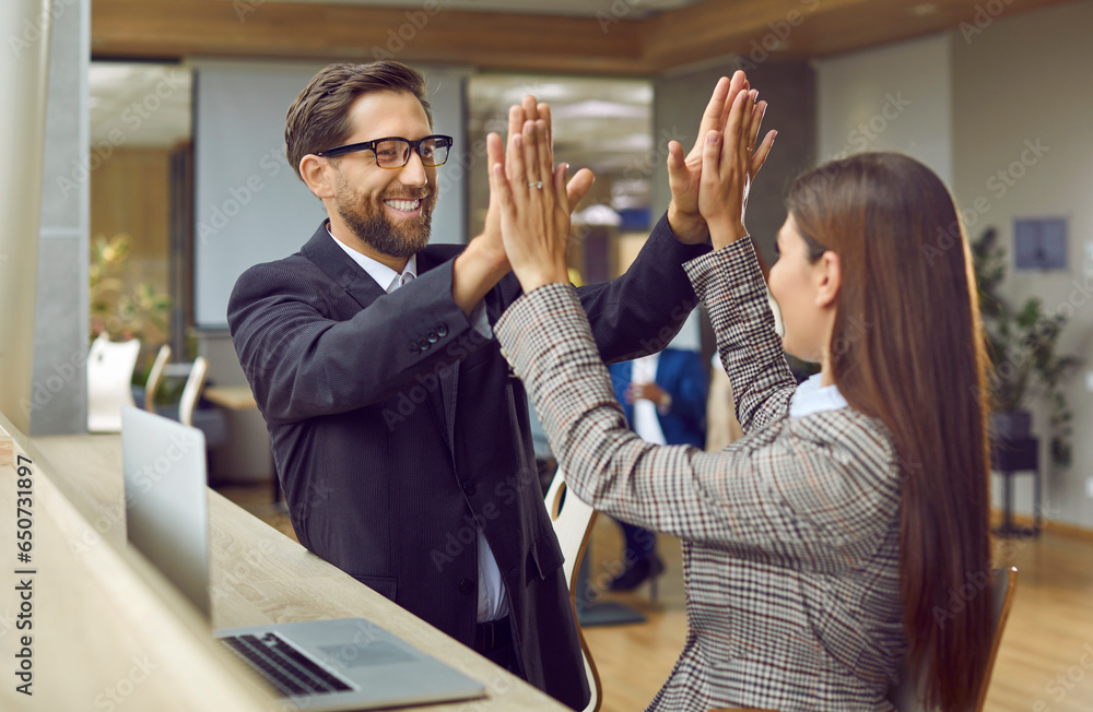 Young happy smiling business man giving high five to a woman rejoicing ...