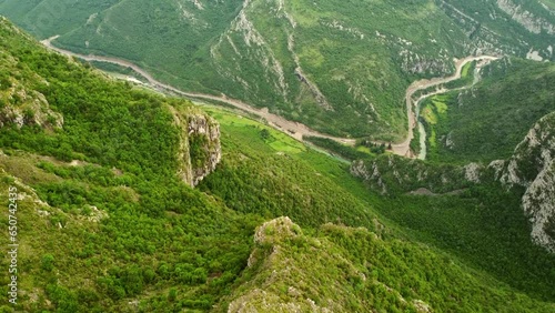 Panoramic aerial scenic drone view to the mountains and the highway and mountain river in the valley. Mountain landscape near Delaj village and aerial view of the border between Montenegro and Albania photo