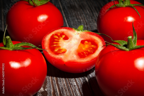 sliced tomato on wood background © bergamont