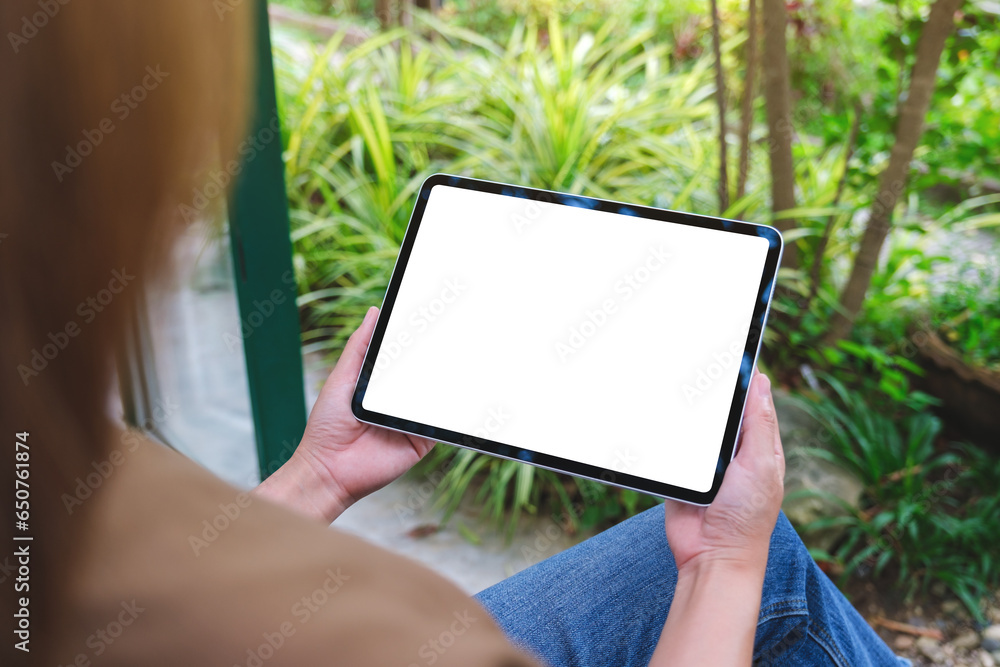 Mockup image of a woman holding digital tablet with blank white desktop screen Mockup image of a woman holding digital tablet with blank white desktop screen
