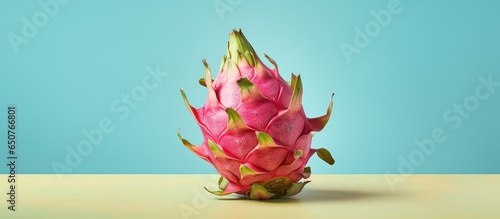 A solo dragon fruit standing out isolated pastel background Copy space photo